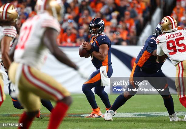 Russell Wilson of the Denver Broncos looks to pass during the first half against the San Francisco 49ers at Empower Field At Mile High on September...