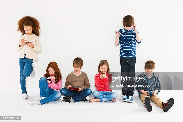 children with different gadgets - boy ipod stock pictures, royalty-free photos & images