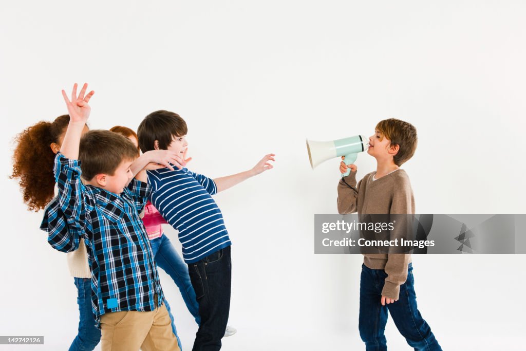 Boy with megaphone, shouting at other children