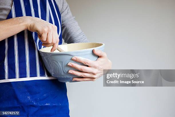 woman with mixing bowl - blue bowl fotografías e imágenes de stock