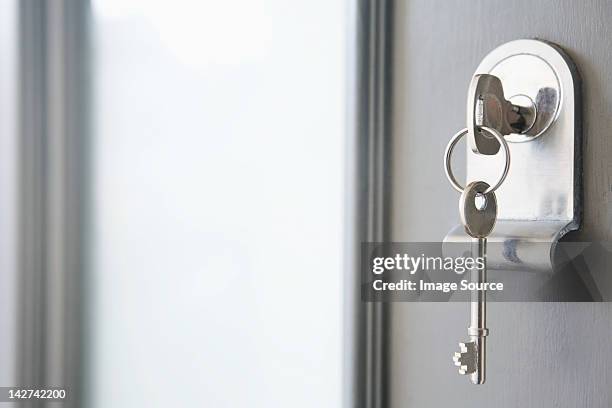 close up of key in a front door - key hole stock pictures, royalty-free photos & images