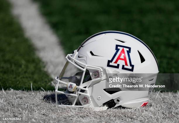 Detailed view of the helmet belonging to quarterback Jayden de Laura of the Arizona Wildcats sitting on the field during pregame warmups prior to...