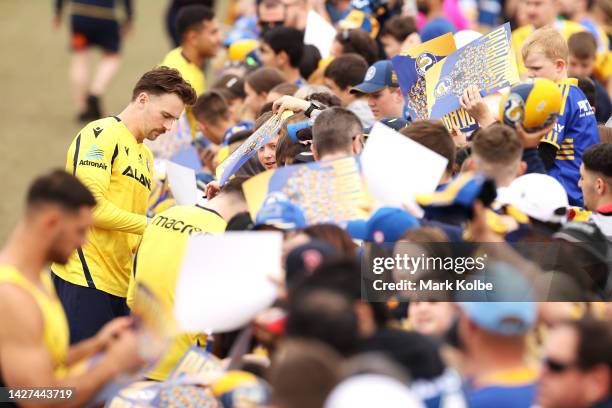 Clinton Gutherson signs autographs during a Parramatta Eels NRL training session at Kellyville Park on September 26, 2022 in Sydney, Australia.