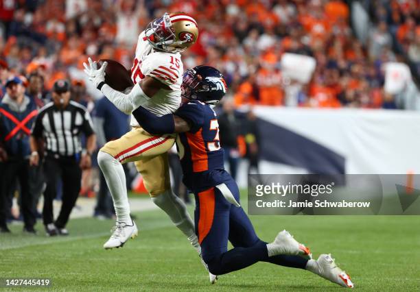 Jauan Jennings of the San Francisco 49ers is tackled by Caden Sterns of the Denver Broncos during the second half at Empower Field At Mile High on...