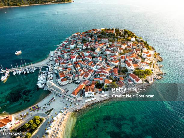 aerial view of an old town of primosten on the adriatic coast at sunset - archipelago stockfoto's en -beelden
