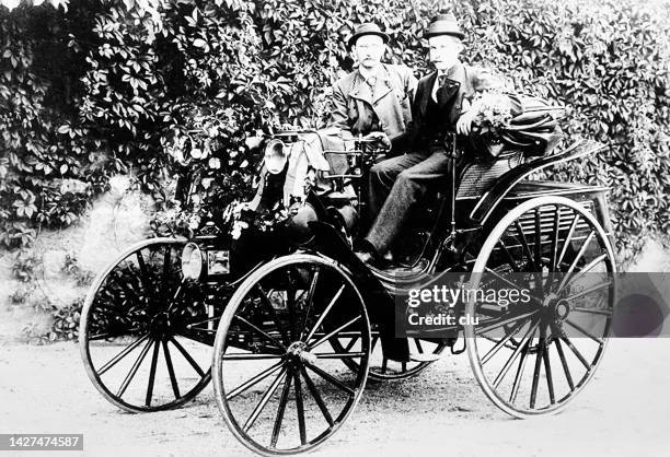 two men on the carl benz car called victoria, four wheels - carriage stock illustrations