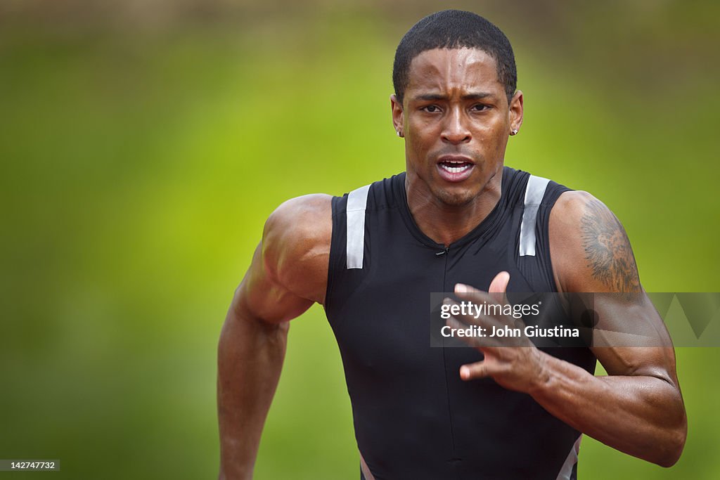 Male sprinter running, close-up