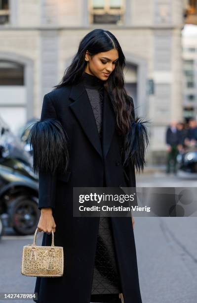 Kiara Nirgin wears black Prada coat, turtleneck Prada, golden bag Prada, golden varnished boots outside CNMI Sustainable Fashion Awards during the...