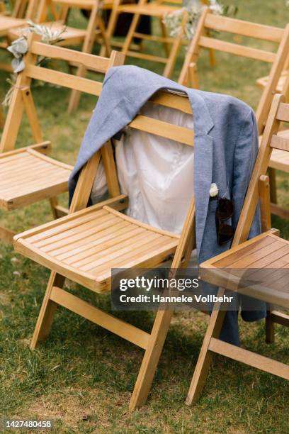 suit jacket hangs over a folding chair - bruiloft - fotografias e filmes do acervo