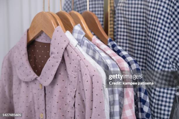 group of pajamas hanging in home - silk pajamas stock pictures, royalty-free photos & images