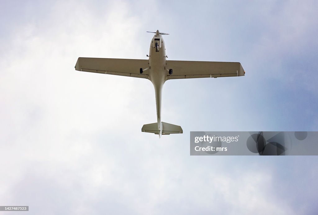 The underside of a small aeroplane in flight