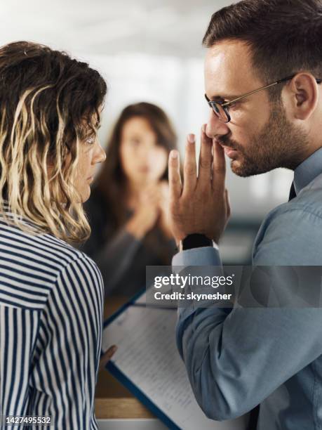 whispering on a job interview! - whispering stock pictures, royalty-free photos & images