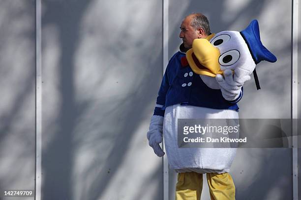 Man dressed as Donald Duck takes a break on the South Bank on April 11, 2012 in London, England. The South Bank, which runs alongside the River...