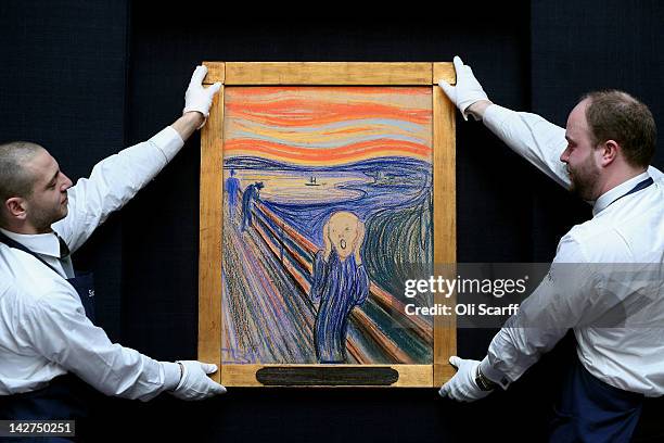 Gallery technicians at Sotheby's auction house adjust 'The Scream' by Edvard Munch on April 12, 2012 in London, England. The iconic painting is on...