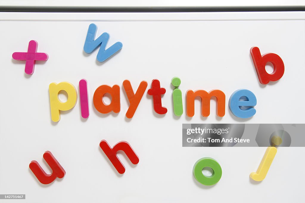 Alphabet fridge magnets spelling 'playtime'