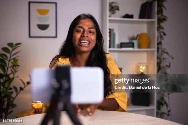 happy indian female vlogger taking during vlog. asian woman recording herself for online video tutorial using mobile phone. - side hustle stock pictures, royalty-free photos & images