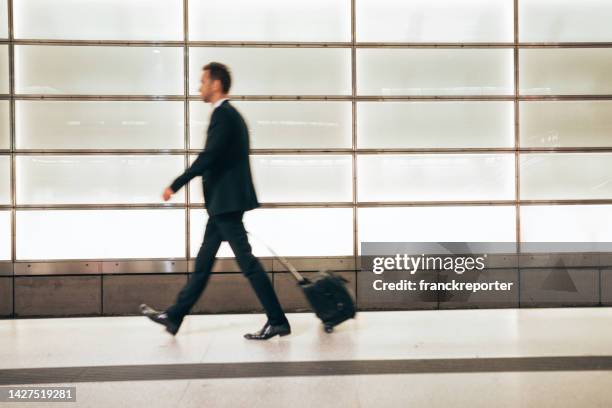 business man walking in the city with luggage - germany v england international friendly stock pictures, royalty-free photos & images