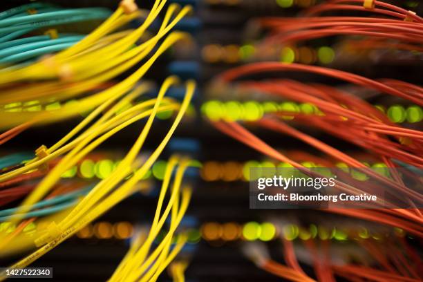 colorful cables connected to a server - fibre broadband stock pictures, royalty-free photos & images