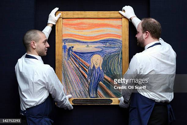 Gallery technicians at Sotheby's auction house stand guard in front of 'The Scream' by Edvard Munch on April 12, 2012 in London, England. The iconic...