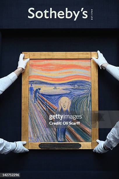 Gallery technicians at Sotheby's auction house hold up 'The Scream' by Edvard Munch on April 12, 2012 in London, England. The iconic painting is on...