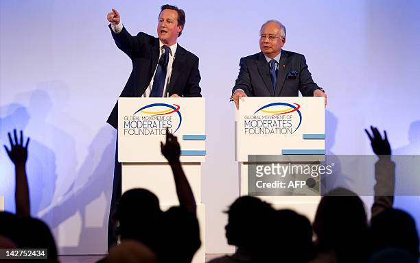 Britain's Prime Minister David Cameron gestures during a question and answer session at the Global Movement of Moderates Foundation dialogue with...