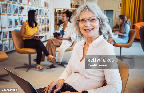 small group of people in the library - associate producer stock pictures, royalty-free photos & images