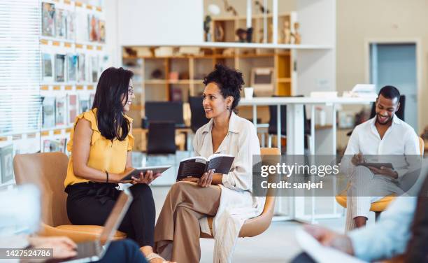 small group of people in the library - publication stock pictures, royalty-free photos & images