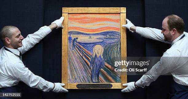 Gallery technicians at Sotheby's auction house adjust 'The Scream' by Edvard Munch on April 12, 2012 in London, England. The iconic painting is on...