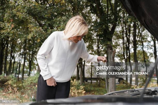 mature woman car repairs on the road - overheated stock pictures, royalty-free photos & images