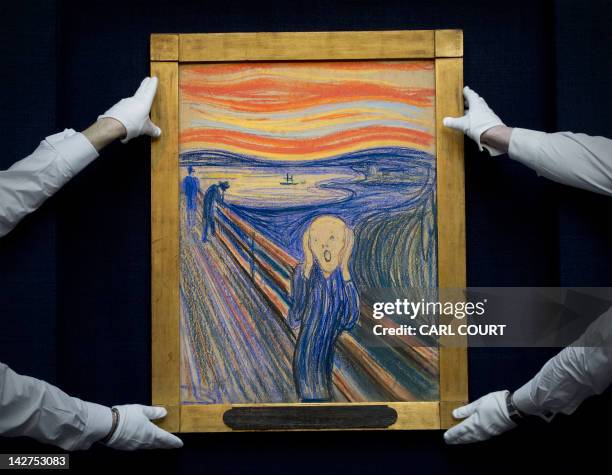 Sotheby's employees pose with Norwegian artist Edvard Munch's 1895 pastel on board version of 'The Scream' at Sotheby's auction house in central...