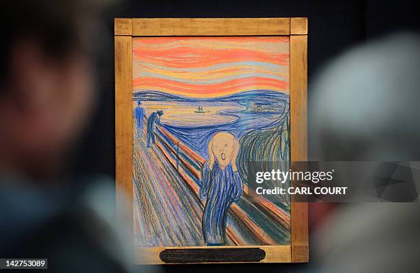 People view the Norwegian artist Edvard Munch's 1895 pastel on board work entitled 'The Scream' at Sotheby's auction house in central London on April...