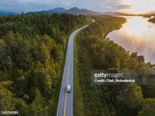 scenic aerial view of truck on the road near the lake in norway - norwegian culture stockfoto's en -beelden
