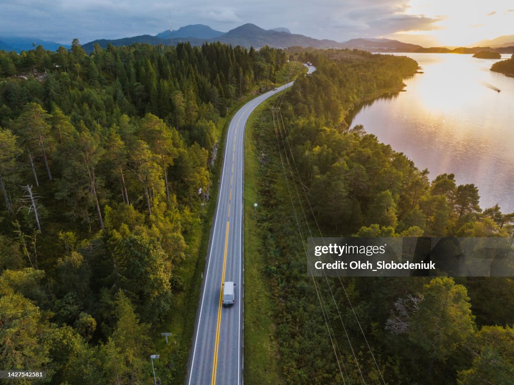 Scenic aerial view of truck on the road near the lake in Norway