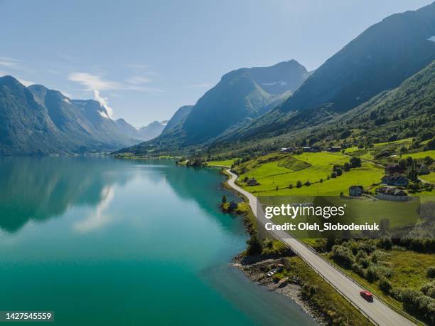 aerial view of car on the road near turquoise  lake in norway - car aerial view stock pictures, royalty-free photos & images