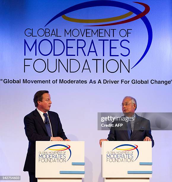 Malaysia's Prime Minister Najib Razak and Britain's Prime Minister David Cameron chat at the Global Movement of Moderates Foundation dialogue during...