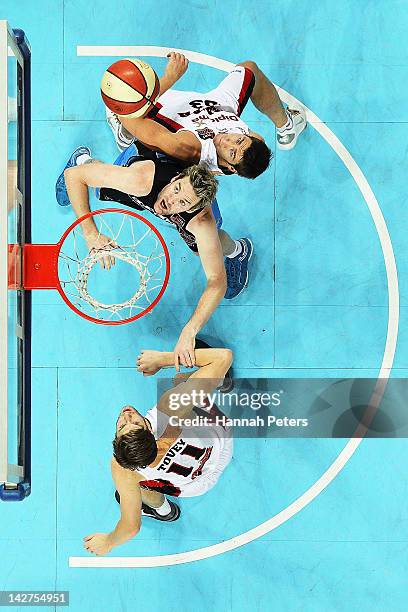 Cameron Tovey and Drew Williamson defend agsinst Dillon Boucher of the Breakers during game one of the NBL Grand Final series between the New Zealand...