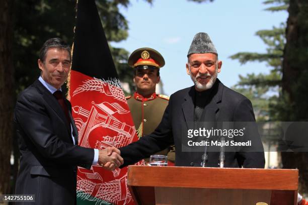 Secretary General Anders Fogh Rasmussen shakes hands with Afghan President Hamid Karzai during a joint press conference, at the Presidential palace...
