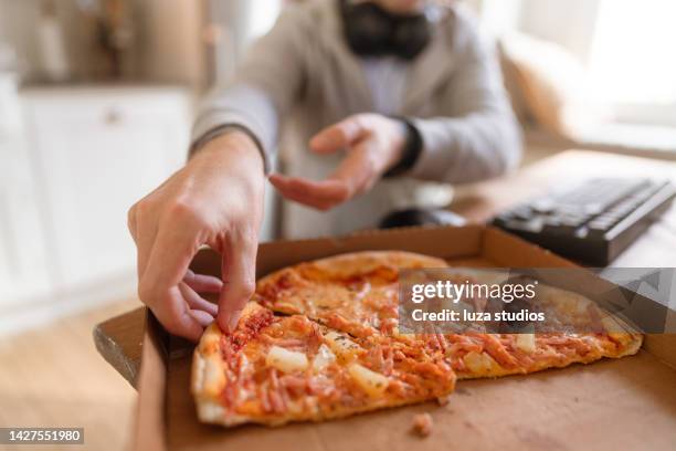 a gamer grabbing a slice of pizza - pizza with ham stock pictures, royalty-free photos & images