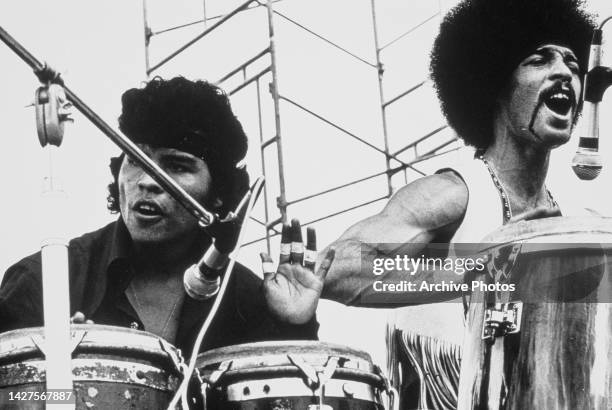 Nicaraguan percussionist Jose Areas and American percussionist Michael Carabello on stage as their band 'Santana' perform at the Woodstock Music and...