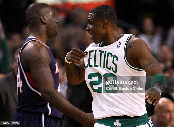 Boston Celtics small forward Mickael Pietrus points to his jersey after burying a 3 point shot in front of Atlanta Hawks forward Ivan Johnson during...