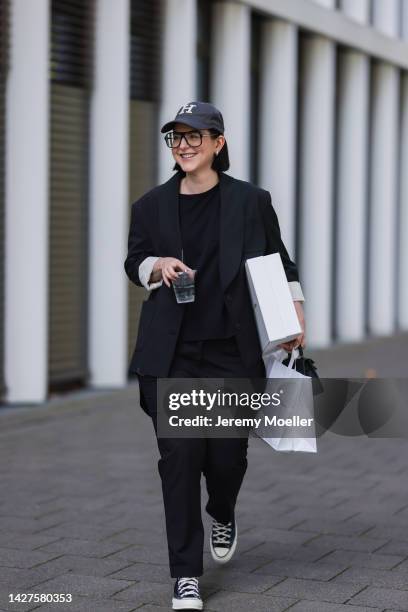 Maria Barteczko seen wearing a black classic blazer by WENDYKEI, a black longsleeve by WENDYKEI, WENDYKEI black skinny pants, a grey logo baseball...