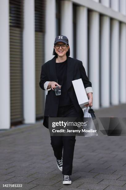 Maria Barteczko seen wearing a black classic blazer by WENDYKEI, a black longsleeve by WENDYKEI, WENDYKEI black skinny pants, a grey logo baseball...