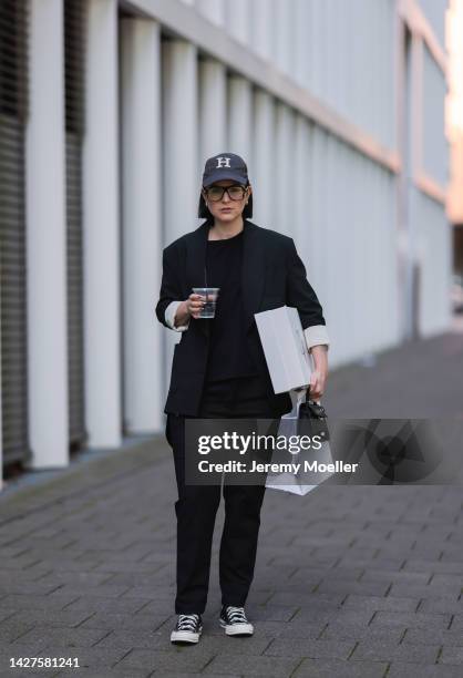 Maria Barteczko seen wearing a black classic blazer by WENDYKEI, a black longsleeve by WENDYKEI, WENDYKEI black skinny pants, a grey logo baseball...