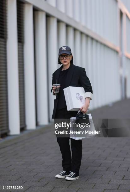 Maria Barteczko seen wearing a black classic blazer by WENDYKEI, a black longsleeve by WENDYKEI, WENDYKEI black skinny pants, a grey logo baseball...