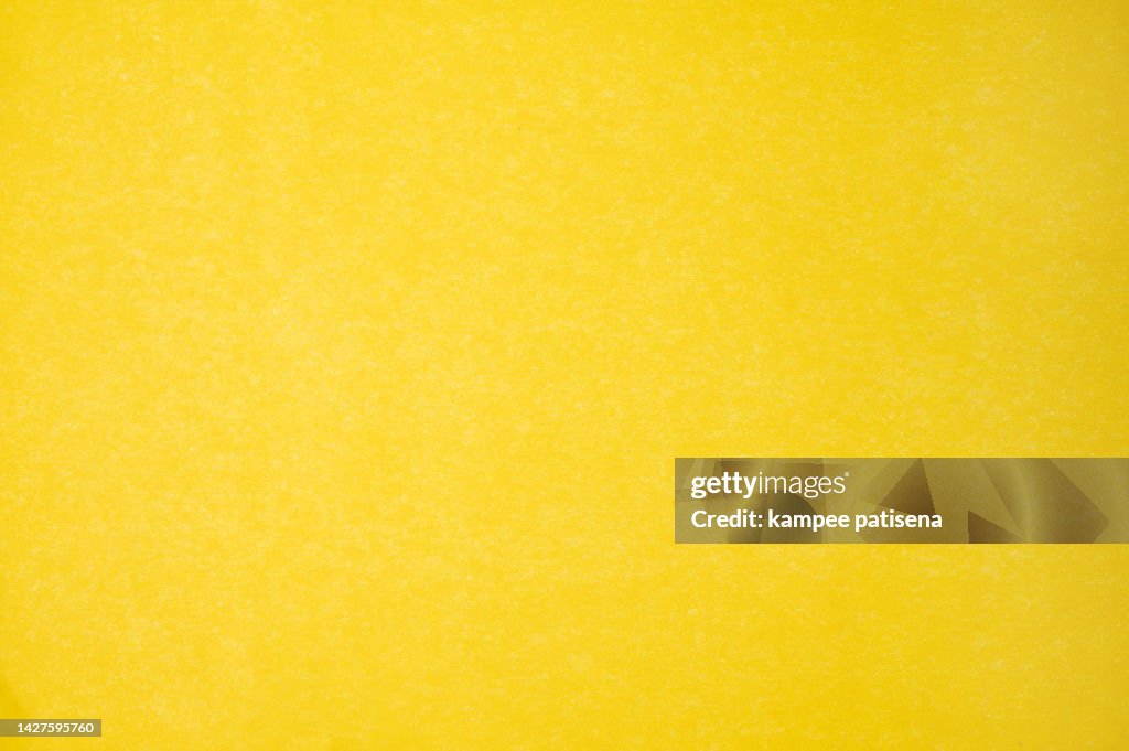 Yellow wax paper sheet texture abstract background.