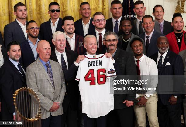 President Joe Biden poses with a jersey gifted to him by the Atlanta Braves as he welcomes the 2021 World Series champion team to the White House,...