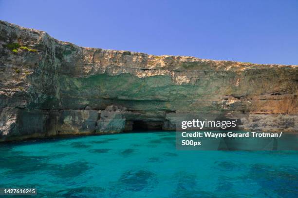 scenic view of sea against clear blue sky,blue lagoon,malta - wayne gerard trotman stockfoto's en -beelden