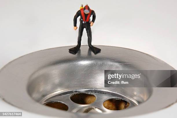 diver at the drain - sink plug stock pictures, royalty-free photos & images