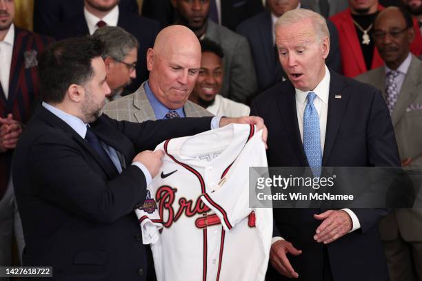 President Joe Biden receives an Atlanta Braves jersey from Braves Manager Brian Snitker and Braves General Manager Alex Anthopoulos while welcoming...