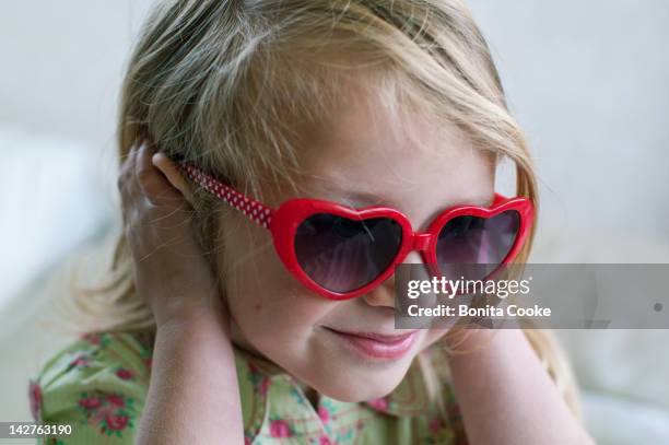 smiling girl in heart sunglasses - not listening stock pictures, royalty-free photos & images